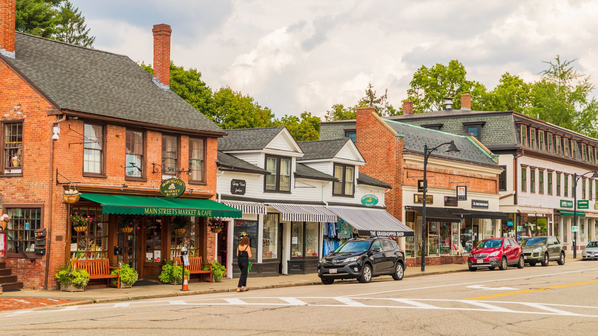 Toddlers in costumes getting candy from Main Street shops in Concord Center