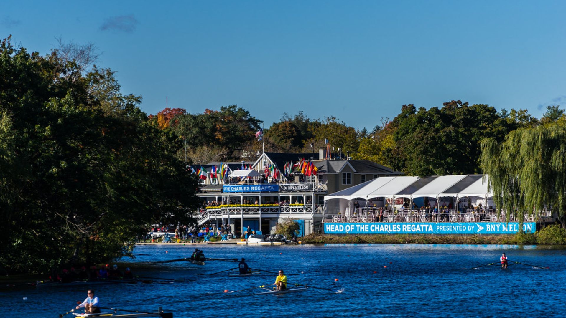 Head of the Charles Regatta on the Charles River in Boston during peak fall foliage